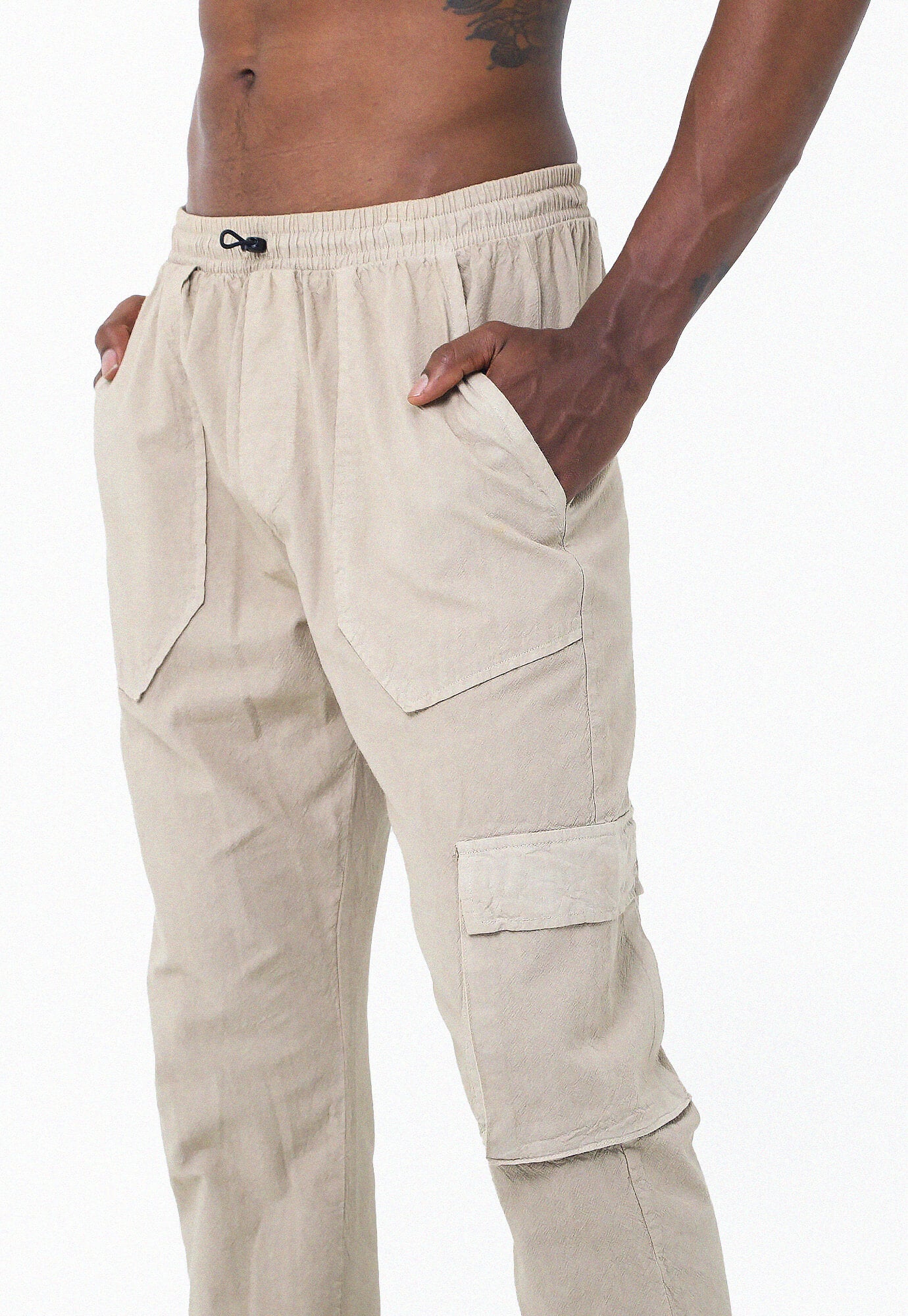 Pantalón arena tipo cargo, bolsillos laterales y botas con elástico para hombre