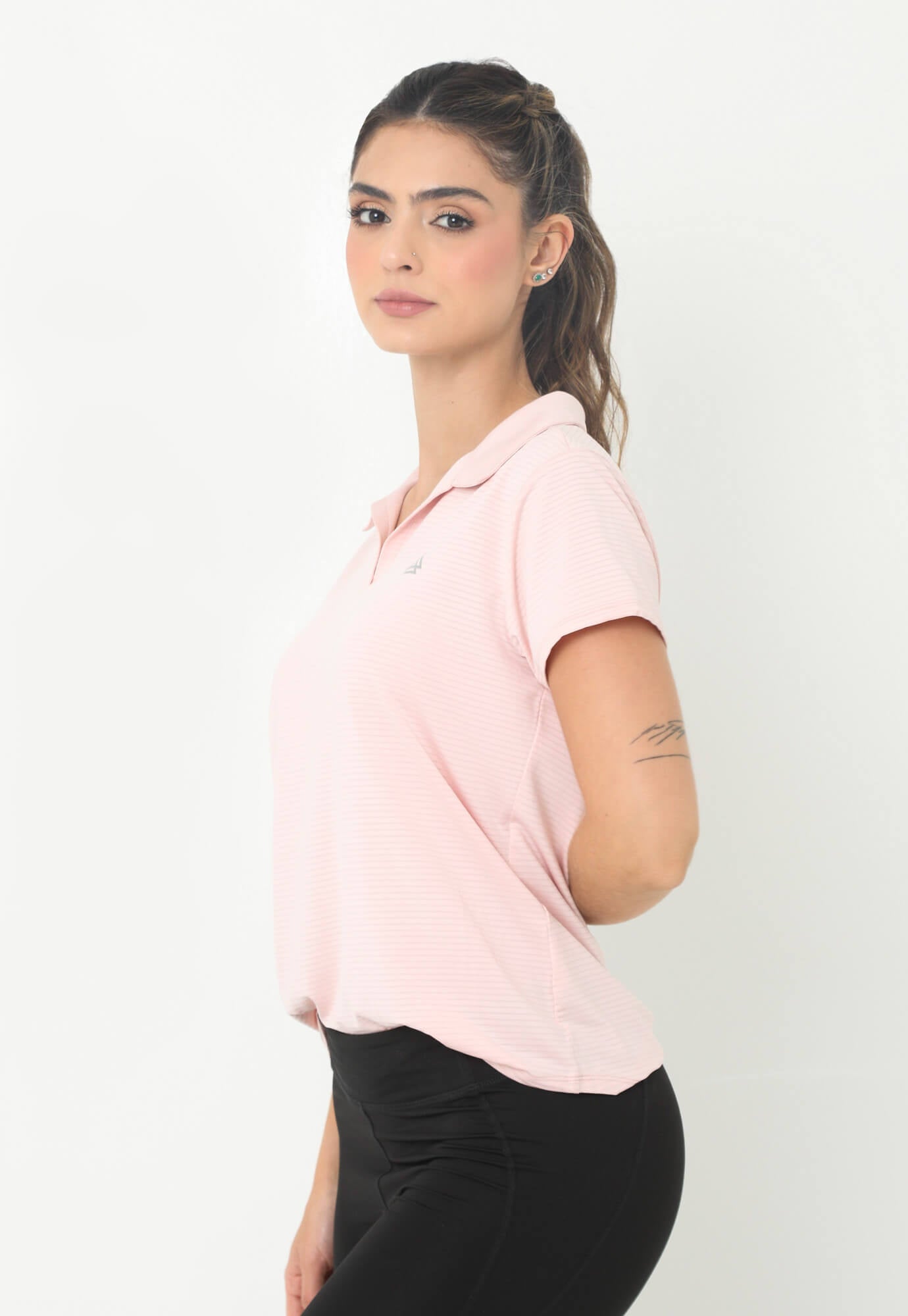 Camiseta deportiva rosada con cuello camisero y transfer reflectivo en frente para mujer