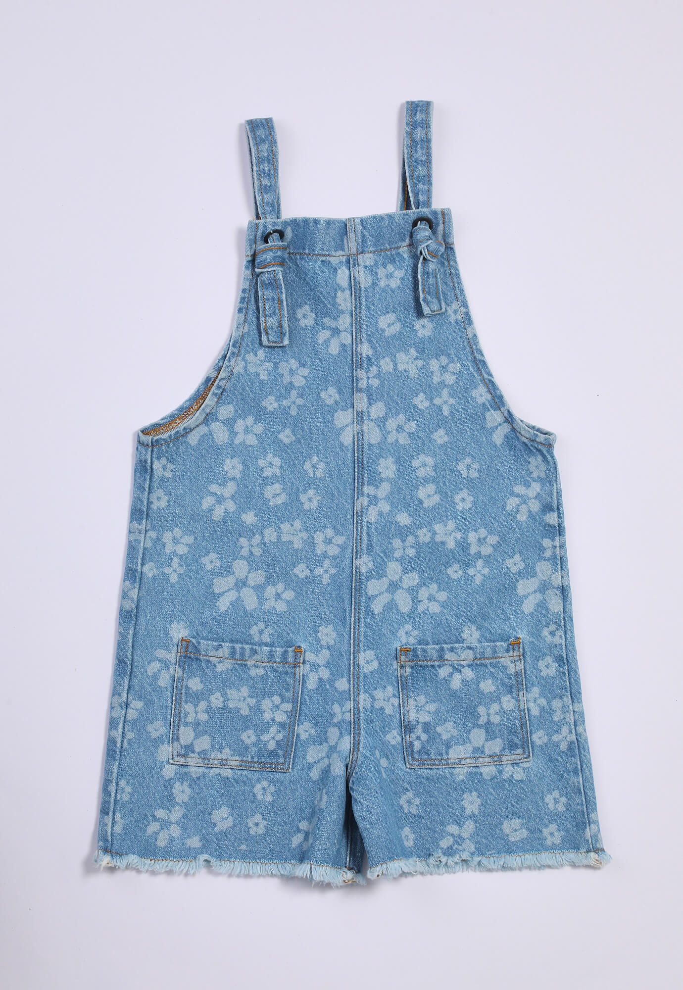 Overol azul índigo sublimado con bolsillos tipo parche y cargaderas para bebé niña