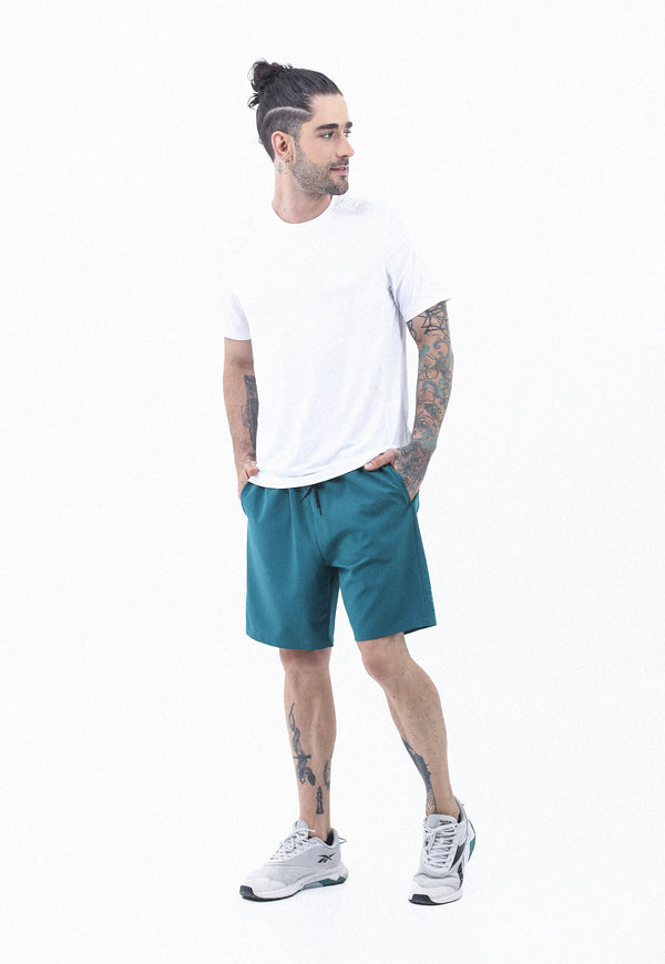 Pantaloneta deportiva verde esmeralda, cintura con elastico y cordon ajustable, bolsillos funcionales y ciclista interno para hombre.